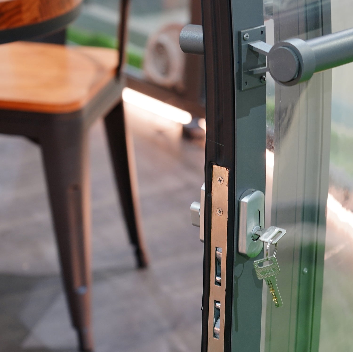 Alt text: "Close-up of a secure lock and key on a glass door of a geodesic dome, showcasing the premium quality and stylish design of glamping solutions offered by the company. Ideal for creating a luxury Airbnb or a sustainable off-grid living space."