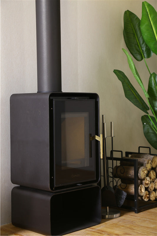 A modern wood-burning stove with a sleek black design, situated in a cozy glamping setup. The stove is accompanied by a log holder filled with firewood, enhancing the ambiance of a luxury geodesic dome or glamping pod. Perfect for sustainable living and creating a warm atmosphere in a dome home or backyard dome.